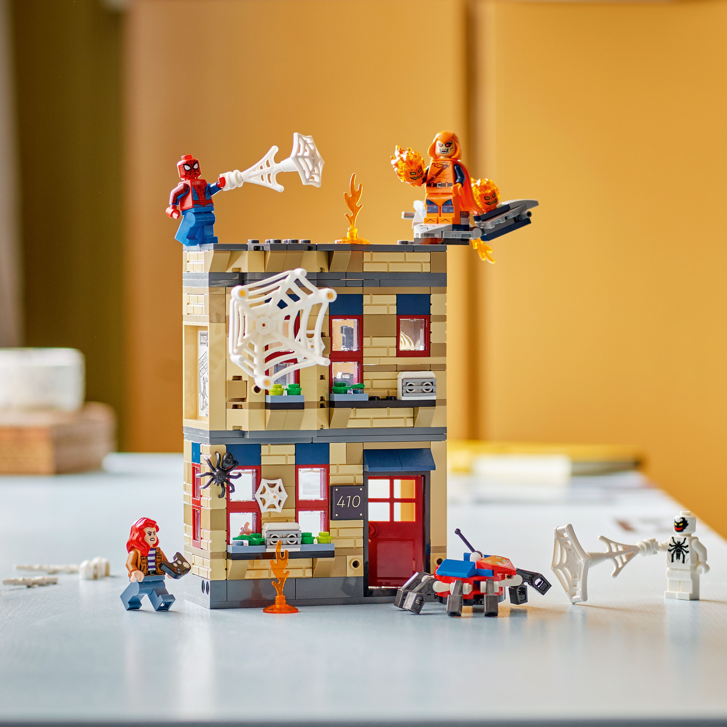 LEGO Marvel Spider-Man Peter Parker's Apartment set, on the table with yellow wall in the background
