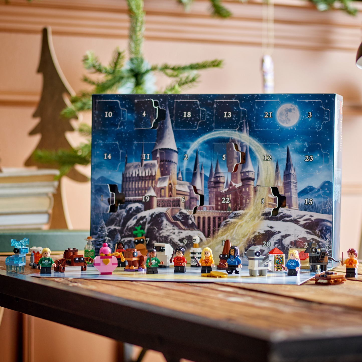 Advent calendar with Harry Potter-themed design and figures on a wooden table.