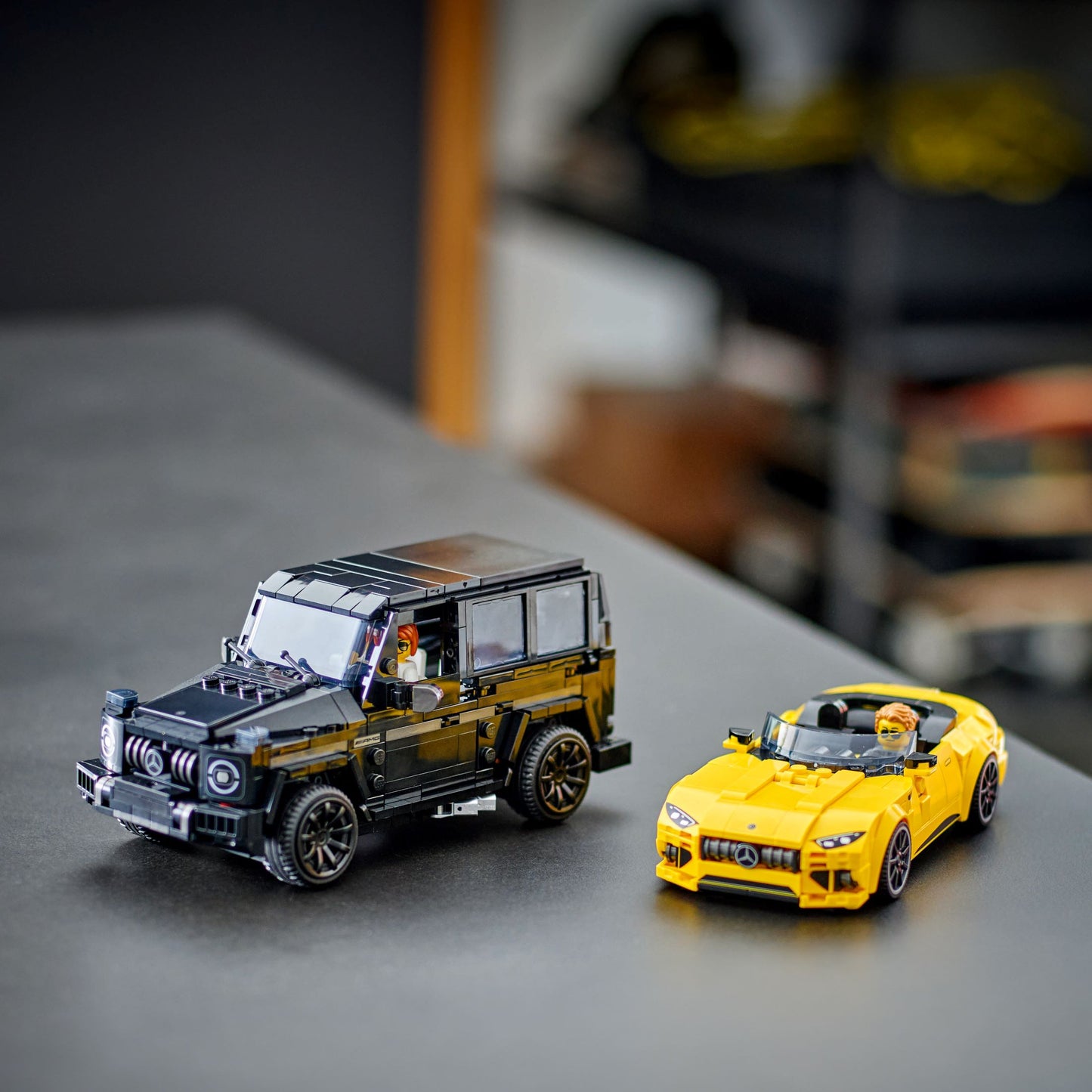 LEGO Speed Champions set featuring models of Mercedes-AMG G63 and Mercedes-AMG SL63 on a table.