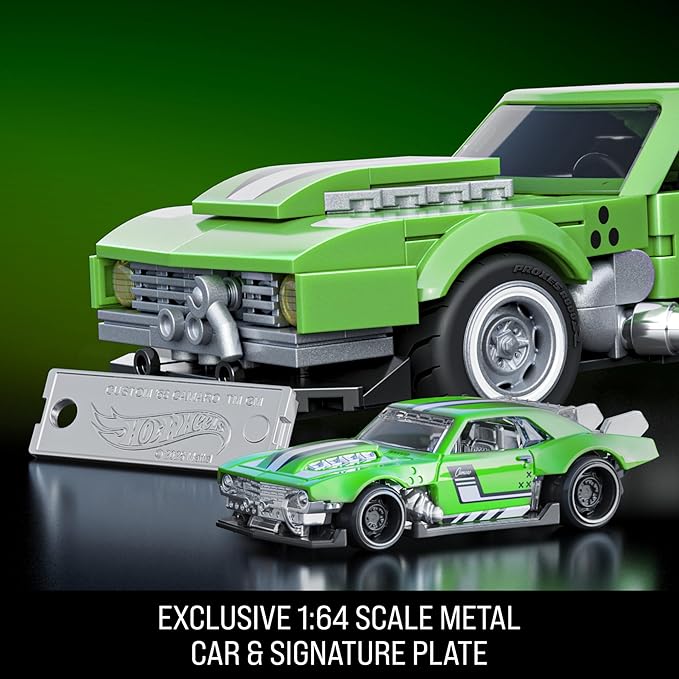 Green toy car with a signature plate on a reflective surface against a green background