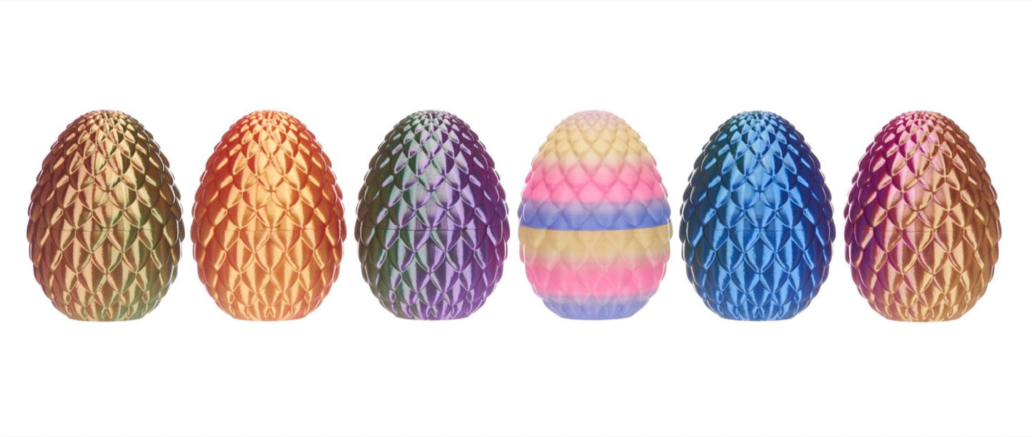 Set of colorful snake eggs with textured surfaces on a white background
