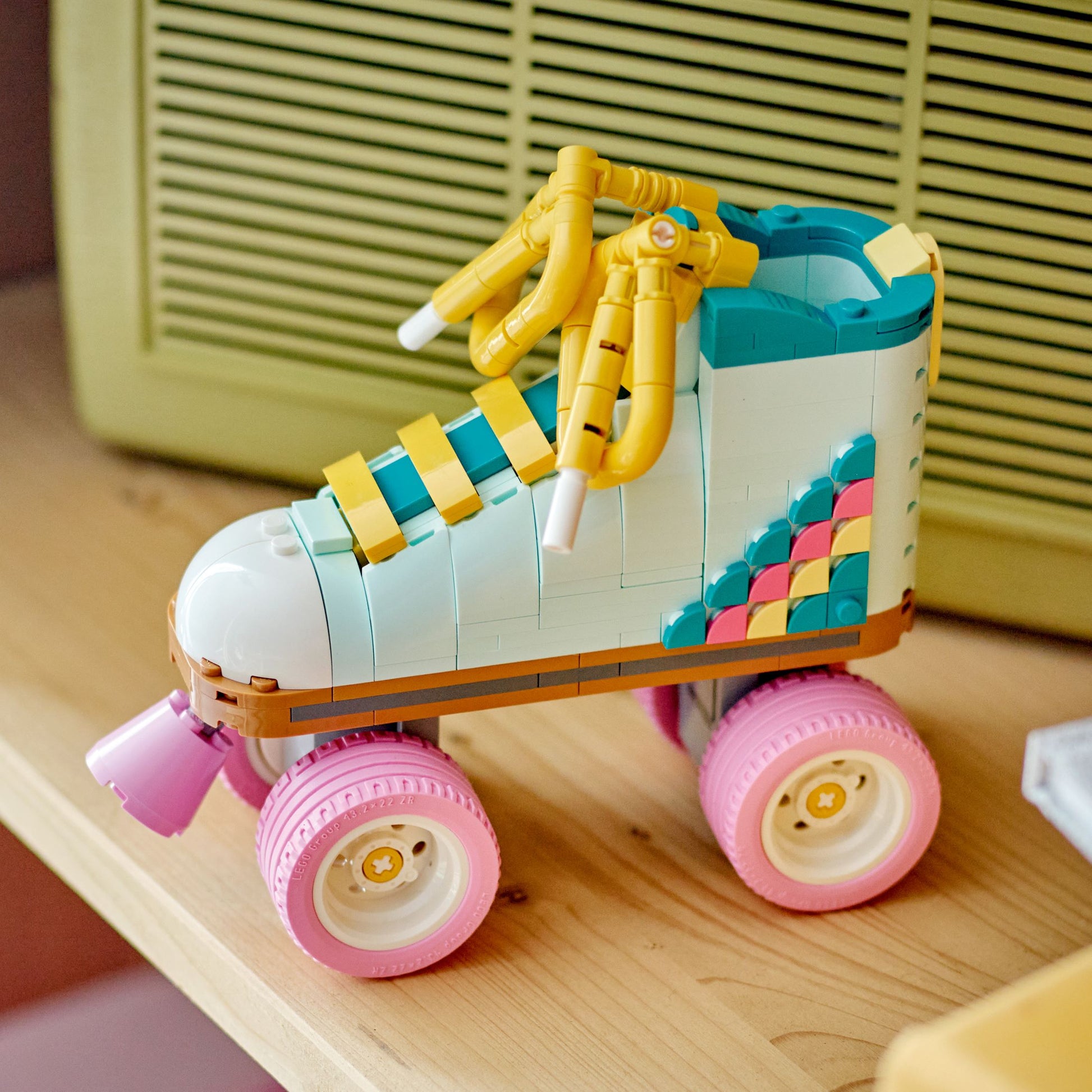 Colorful toy roller skate on a wooden surface with a blurred background