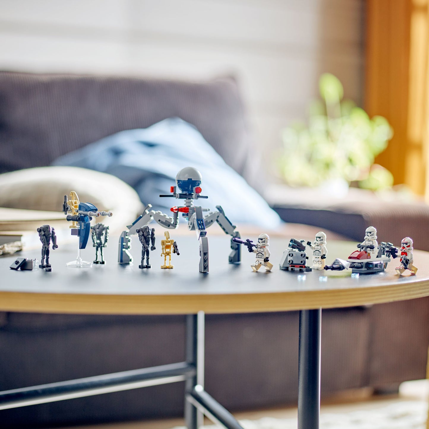 Collection of robot toy figures on a table with a blurred indoor background
