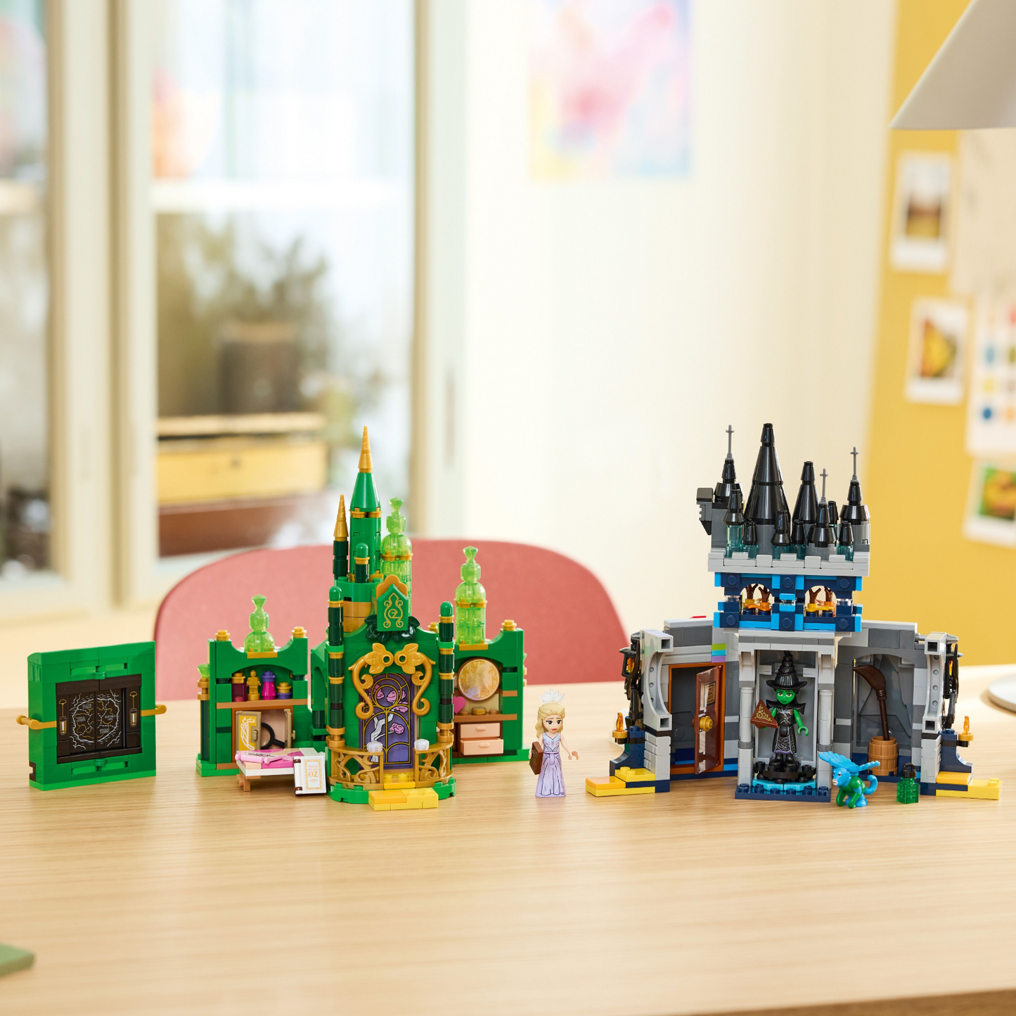 Two toy castle sets on a table with a blurred indoor background