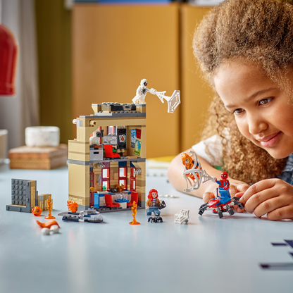 Child playing with LEGO Marvel Spider-Man Peter Parker's Apartment set, on table 