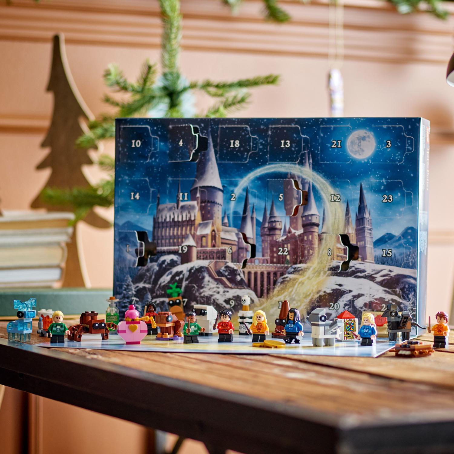 Advent calendar with Harry Potter-themed design and figures on a wooden table.