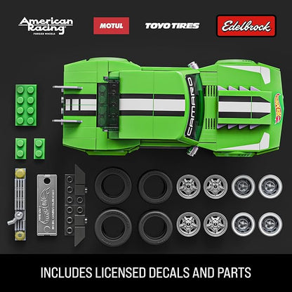 Green toy car set with components and branded logos on a black background