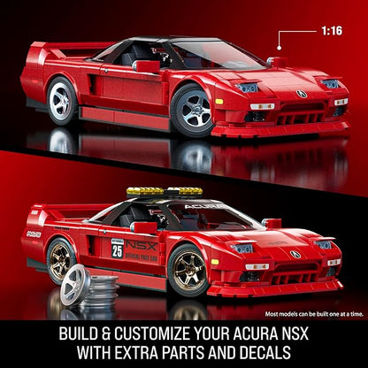 Red Acura NSX model car with additional parts and decals on a reflective red surface.