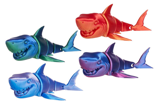 Four colorful shark toys on a white background